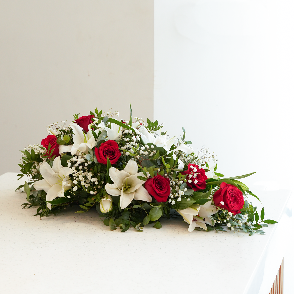 
              Red Roses and White Lily Funeral Spray