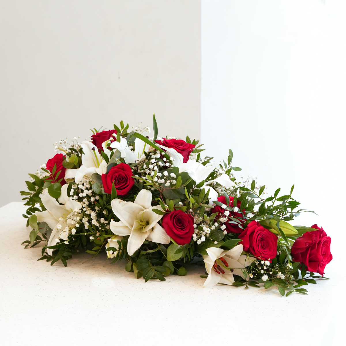 
              Red Roses and White Lily Funeral Spray